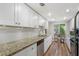 Bright kitchen with granite countertops, stainless steel appliances, and wood floors at 46 Ivy Ne Rdg, Atlanta, GA 30342
