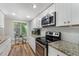 Bright, functional kitchen with white cabinets, stainless steel appliances, and granite counters at 46 Ivy Ne Rdg, Atlanta, GA 30342