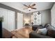 The living room features a ceiling fan, hardwood floors, a sectional sofa and decor to maximize the space at 46 Ivy Ne Rdg, Atlanta, GA 30342