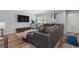 Comfortable living room with a large sectional sofa, modern entertainment center, and bright natural light at 46 Ivy Ne Rdg, Atlanta, GA 30342