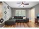 Comfortable living room features a large sectional sofa, hardwood floors, a ceiling fan, and natural light at 46 Ivy Ne Rdg, Atlanta, GA 30342