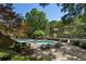 Community swimming pool framed by mature trees and landscaping with ample seating for residents and guests at 46 Ivy Ne Rdg, Atlanta, GA 30342