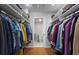 Spacious walk-in closet with custom shelving and rod system for optimal storage with a view to the bathroom at 46 Ivy Ne Rdg, Atlanta, GA 30342