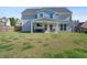 Large, grassy backyard with a covered patio, perfect for outdoor activities and enjoying the peaceful surroundings at 55 Clubhouse Way, Acworth, GA 30101