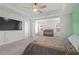 Spacious bedroom with a crib and baby station and light green accent wall at 55 Clubhouse Way, Acworth, GA 30101
