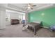 Spacious bedroom with a crib and baby station and light green accent wall at 55 Clubhouse Way, Acworth, GA 30101