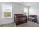 Bedroom featuring a wood crib, a baby changing station, and natural light at 55 Clubhouse Way, Acworth, GA 30101