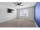 Comfortable bedroom features a ceiling fan, window, and blue accent wall at 55 Clubhouse Way, Acworth, GA 30101