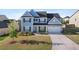 Charming two-story home featuring a well-manicured lawn and a two-car garage at 55 Clubhouse Way, Acworth, GA 30101
