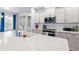 Modern kitchen with white cabinets, stainless steel appliances, and a large island with a white countertop at 55 Clubhouse Way, Acworth, GA 30101