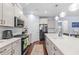 Kitchen with gray cabinets, pendant lighting, and stainless steel appliances at 55 Clubhouse Way, Acworth, GA 30101