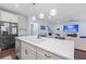 Open-concept kitchen with stainless steel appliances and a large island with seating, open to the living area at 55 Clubhouse Way, Acworth, GA 30101