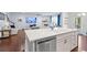 Open-concept kitchen with stainless steel appliances and a large island, flowing into the living room at 55 Clubhouse Way, Acworth, GA 30101