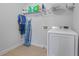 Functional laundry room with shelving, washer, dryer and space-saving ironing board at 55 Clubhouse Way, Acworth, GA 30101