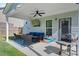 Inviting covered patio featuring a ceiling fan, comfortable seating, and a barbecue grill for outdoor entertaining at 55 Clubhouse Way, Acworth, GA 30101