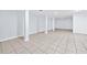 Basement area featuring tiled floor and support pillars at 3210 Roseheath Ln, Lithonia, GA 30038