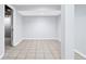Unfinished basement features tile flooring, white walls and ceiling, offering a clean and open space at 3210 Roseheath Ln, Lithonia, GA 30038