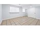 Finished basement featuring window, neutral walls, and tiled flooring, creating bright and functional area at 3210 Roseheath Ln, Lithonia, GA 30038