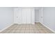 Finished basement with large closet, neutral walls, and tiled flooring, offering storage and style at 3210 Roseheath Ln, Lithonia, GA 30038