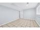 Finished basement with open doorway, neutral walls, and tiled flooring, creating an inviting living space at 3210 Roseheath Ln, Lithonia, GA 30038