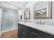 Modern bathroom with double sink vanity, framed mirrors, and tiled glass shower enclosure at 3210 Roseheath Ln, Lithonia, GA 30038