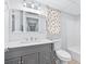 Bathroom featuring vanity with granite counter, mirror, toilet, and tub/shower, creating a functional space at 3210 Roseheath Ln, Lithonia, GA 30038