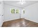 An airy bedroom featuring hardwood floors, neutral walls, and a ceiling fan at 3210 Roseheath Ln, Lithonia, GA 30038