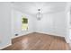 Bright dining room with beautiful wood floors and a modern chandelier at 3210 Roseheath Ln, Lithonia, GA 30038