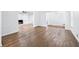 Cozy living room with a brick fireplace, built-in shelves, and hardwood floors at 3210 Roseheath Ln, Lithonia, GA 30038