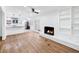 Inviting living room featuring a cozy fireplace, hardwood floors, and an open layout at 3210 Roseheath Ln, Lithonia, GA 30038