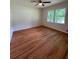 Spacious bedroom with refinished hardwood flooring and natural light from the two large windows at 3352 Northbrook Dr, Atlanta, GA 30340