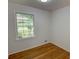 Bedroom featuring a large double-paned window and hardwood floors for a relaxing and modern feel at 3352 Northbrook Dr, Atlanta, GA 30340