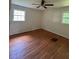 This bedroom features hardwood floors, two windows, and a ceiling fan at 3352 Northbrook Dr, Atlanta, GA 30340