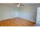 This spacious bedroom features hardwood floors, a ceiling fan, and ample closet space for storage at 3352 Northbrook Dr, Atlanta, GA 30340