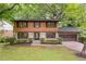 Charming two-story home with wood and brick exterior, lush landscaping, and attached two car garage at 3352 Northbrook Dr, Atlanta, GA 30340