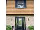 Close up of front door with sidelights flanked by brick and trimmed with black shutters and planters at 3352 Northbrook Dr, Atlanta, GA 30340