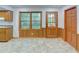Sunny eat-in kitchen features wood cabinets, a trio of windows and backyard access at 3352 Northbrook Dr, Atlanta, GA 30340
