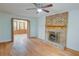 Cozy living room featuring hardwood floors, a brick fireplace with mantle and bi-fold doors to another room at 3352 Northbrook Dr, Atlanta, GA 30340