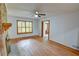 Cozy living room with hardwood floors, a brick fireplace, and natural light from the shuttered window at 3352 Northbrook Dr, Atlanta, GA 30340