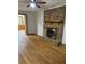 Living room featuring refinished hardwood flooring and a brick fireplace with wood mantle at 3352 Northbrook Dr, Atlanta, GA 30340
