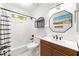Modern bathroom with a vanity, a unique mirror, and a shower-tub combination at 3977 Fox Glen Dr, Woodstock, GA 30189