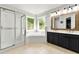 Bright bathroom with dual vanity, soaking tub, a walk-in shower, and lots of light at 3977 Fox Glen Dr, Woodstock, GA 30189