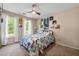 Bright bedroom with ceiling fan, natural light, and a cozy bed with colorful bedding at 3977 Fox Glen Dr, Woodstock, GA 30189