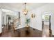 Open dining room with hardwood floors, stylish lighting, and views into the living room and kitchen at 3977 Fox Glen Dr, Woodstock, GA 30189