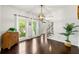 Bright dining room with hardwood floors, large windows, and an open view to the front door at 3977 Fox Glen Dr, Woodstock, GA 30189