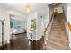 Bright foyer with hardwood floors, staircase, and an open view to the living room at 3977 Fox Glen Dr, Woodstock, GA 30189