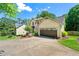 Inviting two-story home featuring lush greenery, a two-car garage, and a welcoming entrance at 3977 Fox Glen Dr, Woodstock, GA 30189