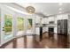 Well-lit kitchen with stainless steel appliances, white cabinets, and access to the back deck at 3977 Fox Glen Dr, Woodstock, GA 30189