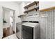 Well-organized laundry room features modern appliances, stylish decor, and ample storage at 3977 Fox Glen Dr, Woodstock, GA 30189