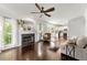 Spacious living room featuring a fireplace, hardwood floors, and a view to the kitchen at 3977 Fox Glen Dr, Woodstock, GA 30189